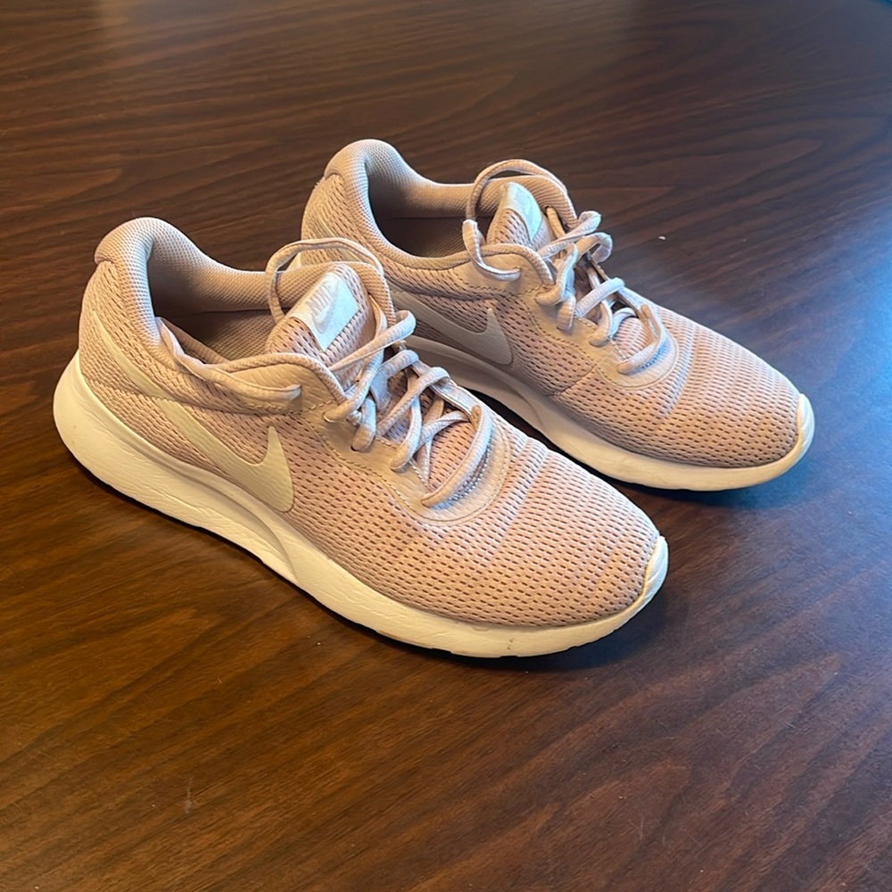 Pink women’s nike running shoe